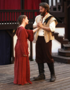Man and woman holding hands in costume