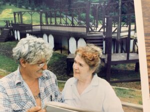 The Robinsons looking over plans with beginnings of stage behind them.